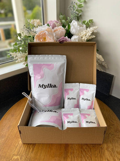 Brown shipping box with final product, both multi-serve and single serve pouches.